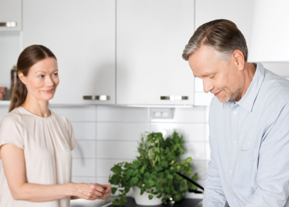 Pariskunta laittamassa ruokaa Hartelan uudiskohteen keittiössä